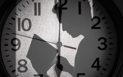 A man's shadow over a clockface to illustrate the article 