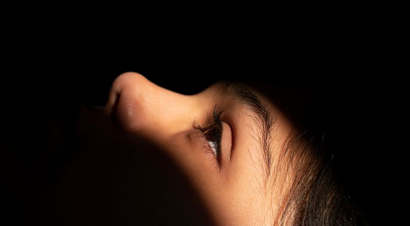 Light shining on a reclining girl's face to illustrate the article Jesus Raises the Dead: The Widow’s Son and Jairus’ Daughter