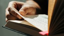 Photo of a person holding a Bible open, to illustrate the article 